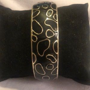 Black enamel and silver tone spring latch bracelet